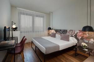 Letto o letti in una camera di Hotel Leopardi