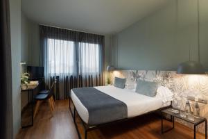Letto o letti in una camera di Hotel Leopardi