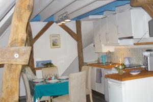a kitchen with a blue table in a room at Gîte La Bulle En Baie, proche Mont Saint-Michel, au calme, pour 4 pers in Crollon