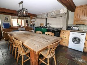 a kitchen with a large wooden table and chairs at Hazel Barn in South Molton