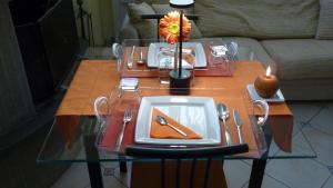 a table with a plate and a flower on it at B&B degli Artisti in Palmi