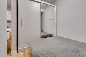 a bedroom with a bed and a sliding glass door at Central Platinum Apartments 16 in Rybnik