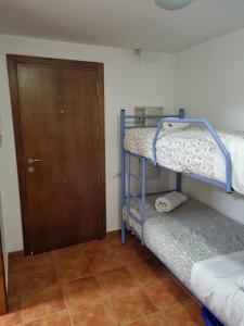a room with two bunk beds and a door at MONTE OIZ ELITE in Sierra Nevada