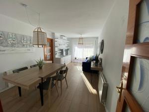 a kitchen and dining room with a table and chairs at Vilamarlux VI in Vilassar de Mar