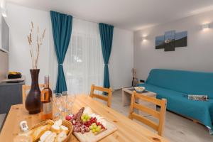 een woonkamer met een tafel met een bord eten bij Apartments Grota in Poreč