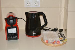 a blender and a tea kettle on a counter at Kalamia's cozy apartment in Pyrgos