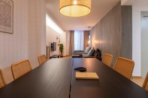 a conference room with a large wooden table and chairs at Moontels Paseo de Ruzafa in Valencia