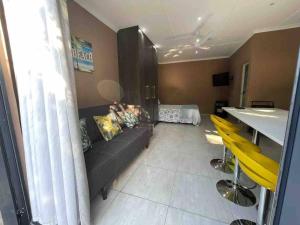 a living room with a couch and a bed at 7th Heaven in Tugela Mouth