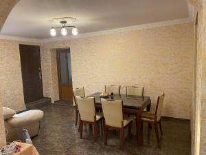 uma sala de jantar com mesa e cadeiras em Friend's House rooms near Airport em Yerevan