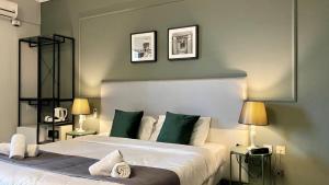 a hotel room with two beds and a lamp at Sliema Marina Hotel in Sliema