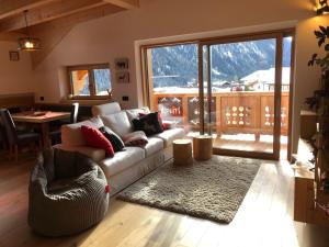 a living room with a couch and a table at Cèsa Prinoth in Campitello di Fassa
