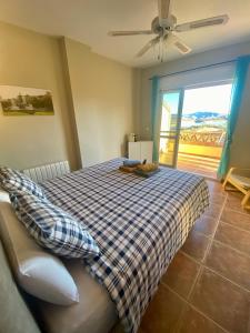 a bedroom with a bed with a checkered blanket at Casa nuestro sueño in Viñuela