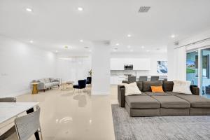 a living room with a couch and a dining room at Mimosa Sunrise Villa in Pompano Beach