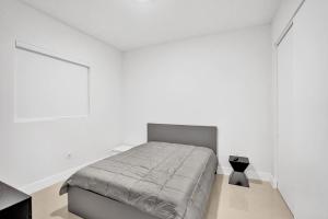 a bedroom with a bed in a white room at Mimosa Sunrise Villa in Pompano Beach +39 photos