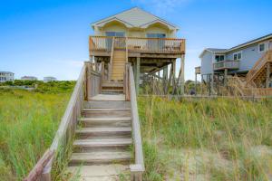 a staircase leading up to a beach house at 1 Anchors Away Oceanfront in Holden Beach