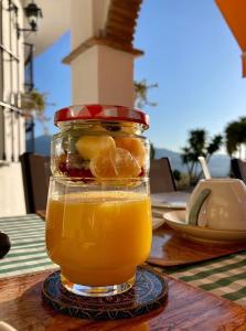 a glass jar of orange juice on a table at Casa nuestro sueño in Viñuela