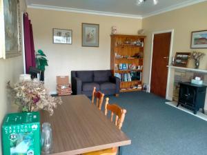 a living room with a table and a blue couch at Grampians Historic Homestead B&B in Moutajup