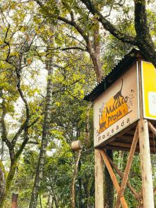 a sign for a monkey park with trees in the background at Macaco Prosa in Macacos