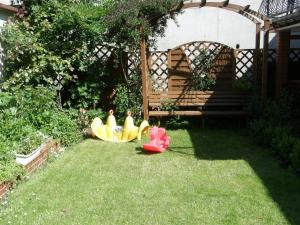 a backyard with two toy boats on the grass at Karolinka leba - FIRST MINUTE SEZON 2026!!! in Łeba +29 photos