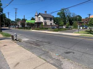 an empty street with a house and a fire hydrant at Cozy place near FedEx Forum- free shuttle to downtown in Memphis
