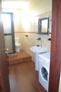 a bathroom with a washing machine and a sink at Apartment is calm locality in Flic-en-Flac