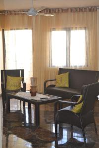 a living room with a couch and a table and chairs at Apartment is calm locality in Flic-en-Flac