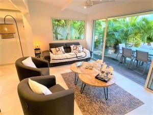 a living room with a couch and chairs and a table at Bora Bora Condo in Marigot