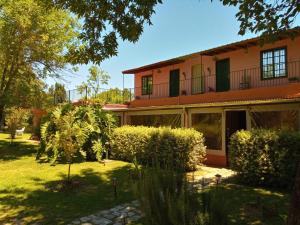 a house with a garden in front of it at Posada Don Salvador in San Antonio de Areco