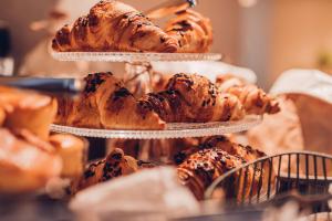 a pile of pastries on three tiers in a bakery at Radisson Blu Aleksanteri Hotel, Helsinki in Helsinki