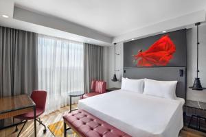 A bed or beds in a room at Radisson RED Chandigarh Mohali