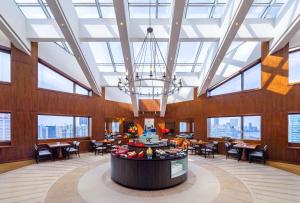 a large room with tables and chairs and windows at Radisson Collection Hyland Shanghai in Shanghai