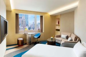 a hotel room with a bed and a window at Radisson Collection Hyland Shanghai in Shanghai
