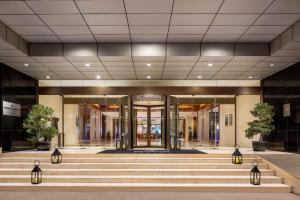 a lobby of a building with stairs in front at Radisson Collection Hyland Shanghai in Shanghai