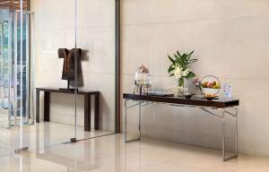 a room with a table with a bowl of fruit on it at Radisson Collection Hyland Shanghai in Shanghai
