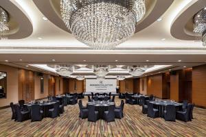 a ballroom with tables and chairs and chandeliers at Radisson Collection Hyland Shanghai in Shanghai