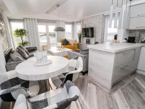 a kitchen and living room with a table and chairs at 23 Valley View in Morpeth