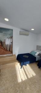 a bedroom with a bed and a painting on the wall at La Mongeta Màgica. in Castellón de la Plana