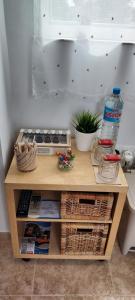 a wooden table with baskets and a water bottle on it at La Mongeta Màgica. in Castellón de la Plana