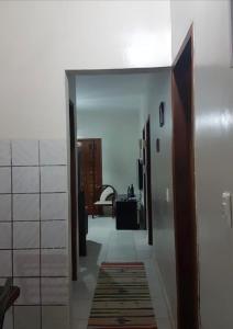 a hallway with white walls and a room with a rug at Casa de praia Luiz Correia paraíso azul in Luis Correia