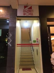 a staircase in a building with a sign on it at Zermatt Hotel in Cameron Highlands