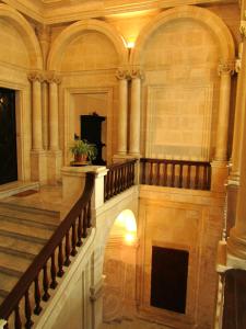 an ornate staircase in a building with a stair case at Palazzo Santa Rosalia in Modica