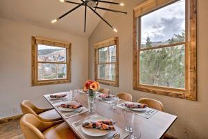 a dining room with a table and chairs and windows at Park City Condo, Walk to Park City Mtn Lifts! in Park City