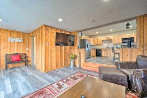 a living room with a couch and a kitchen at Family-Friendly Retreat Less Than 1 Mi to Lake George in Lake George