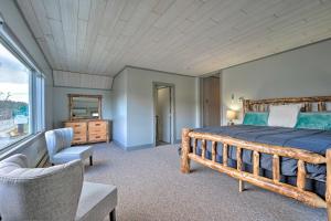 a bedroom with a bed and a chair and a window at Family-Friendly Retreat Less Than 1 Mi to Lake George in Lake George