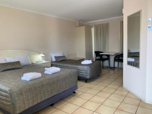 Postel nebo postele na pokoji v ubytování Biloela Palms Motor Inn + 16 fotografií