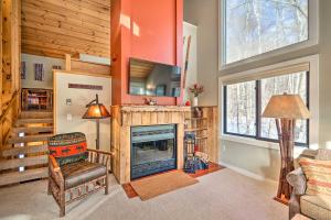 a living room with a fireplace and a tv at Lincoln Condo with Balcony Less Than 2 Mi to Loon Mtn! in Lincoln