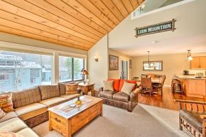 a living room with a couch and a table at Lincoln Condo with Balcony Less Than 2 Mi to Loon Mtn! in Lincoln