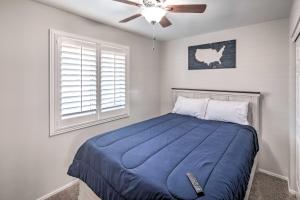 a bedroom with a blue bed with a ceiling fan at Parker Home on the Colorado River with Views! in Parker