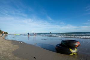 a group of people standing on the beach at Avatara CondoB34 by malai in Mae Pim