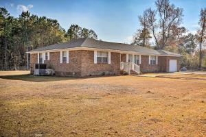 a brick house with a yard in front of it at Moncks Corner Home with Yard Near Lake Moultrie in Moncks Corner